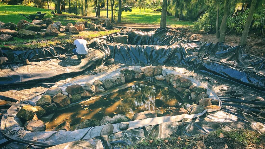 Placing the final rocks and filtration media at Swannie Creek